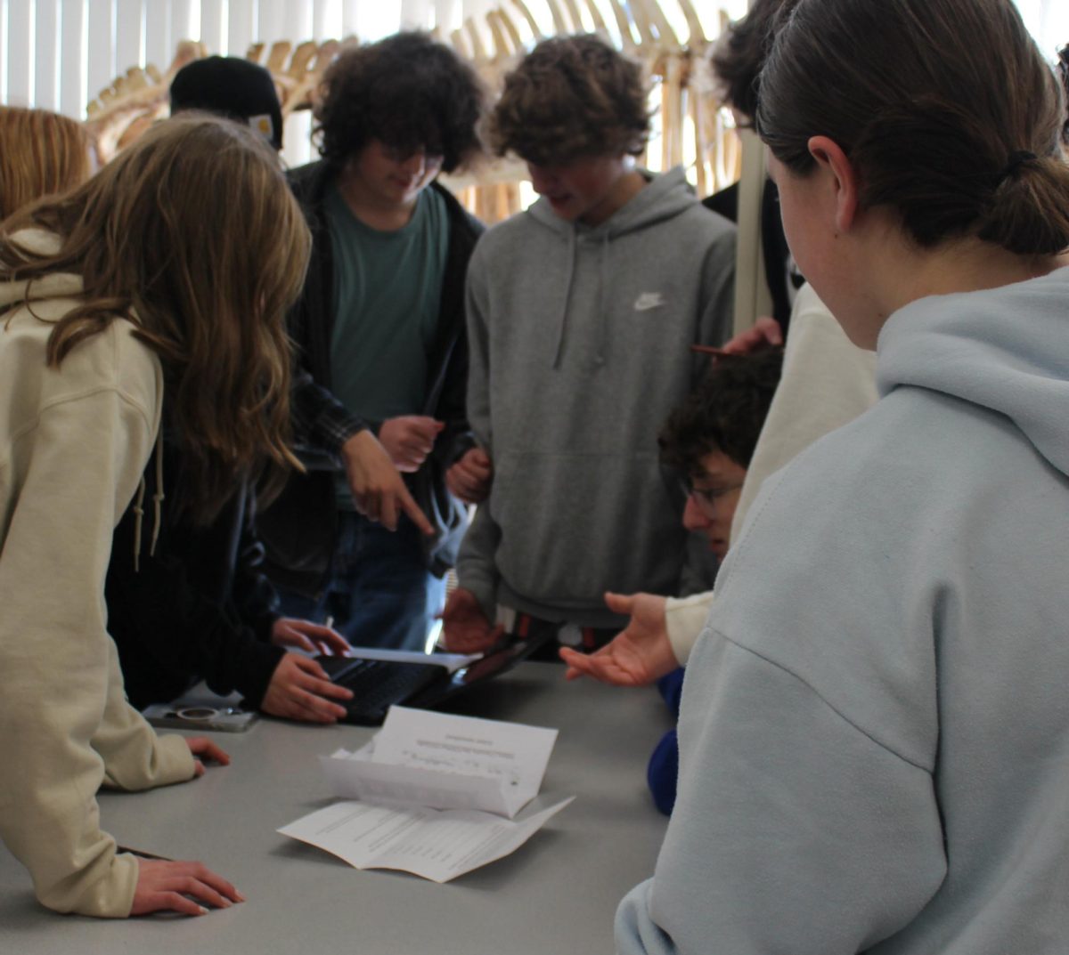 A freshman advisory works to solve a clue during the red-out scavenger hunt Feb. 9 at Nonnewaug.