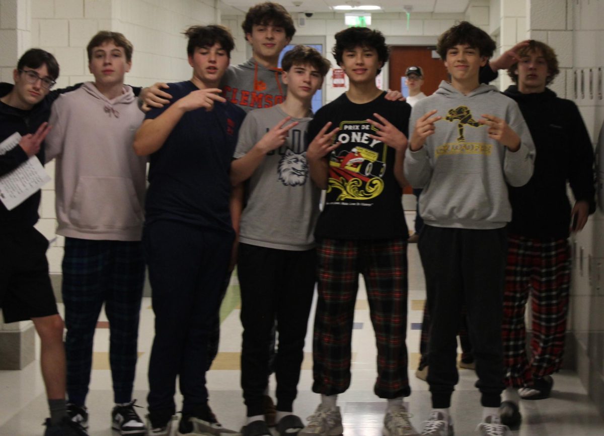 From left, Issac Stevens, James Wolf, Nick Sniffin, Thomas Lengyel, Brycen Gagne, Derek Chung, Ethan Wild, Robert Metcalfe pose during the red-out scavenger hunt Feb. 9 at Nonnewaug. 