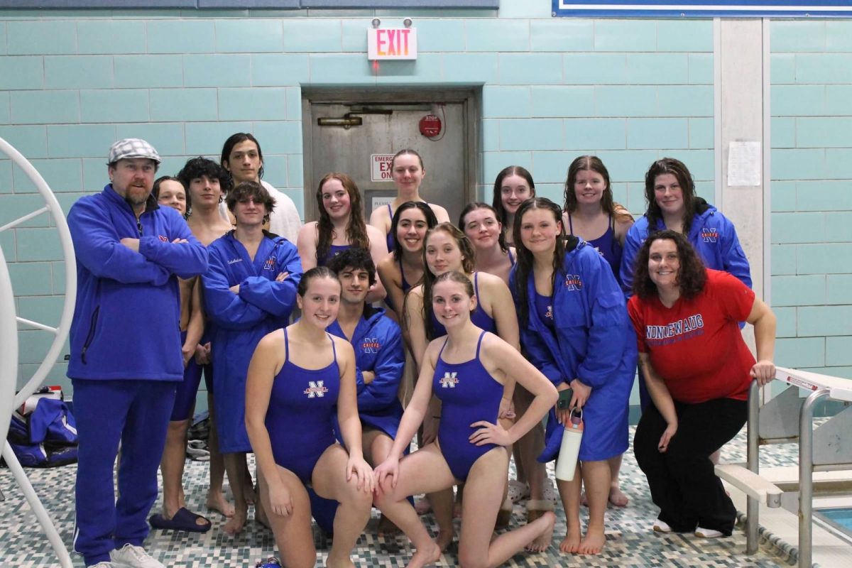 The Nonnewaug swim team poses during a Jan. 29 meet against Litchfield. The Chiefs regularly practice and compete at night since the school doesnt have its own pool.