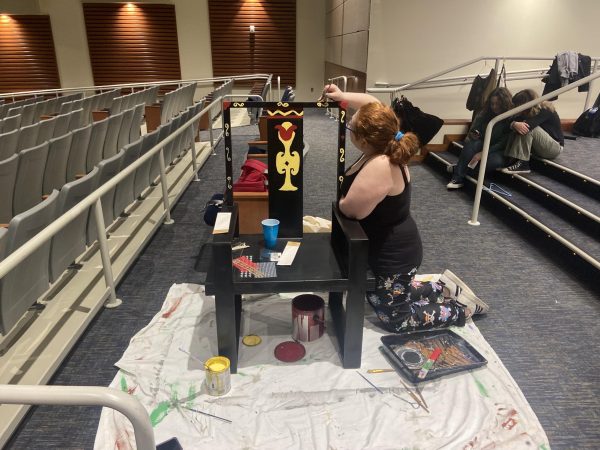 Drama club member and art student Kelsey Santerre-Piaz works on a set piece for this springs show. The drama club utilizes their own materials and creativity to create their engaging backdrops since the club doesnt have its own budget. 
