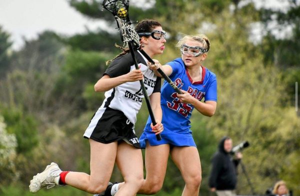 Northwest Uniteds Juliana Bailey, left, defends the ball from a St. Paul player during the 2023 lacrosse season. (Courtesy of Marianthe Glynos)