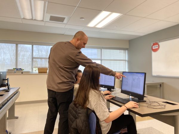 Nonnewaug business and finance teacher Adam Lengyel helps students in one of the financial courses he teaches offered at NHS. The course will be required for graduation for classes after the senior class of 2026.