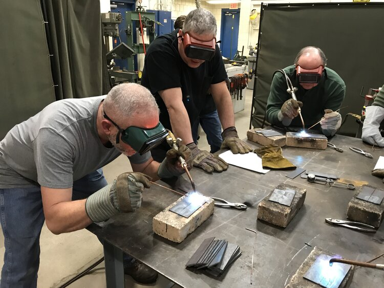 Those taking the Woodbury FFA adult education programs welding course perform torch welding on flat plates of metal together in Nonnewaug’s shop. (Courtesy of the Woodbury FFA)