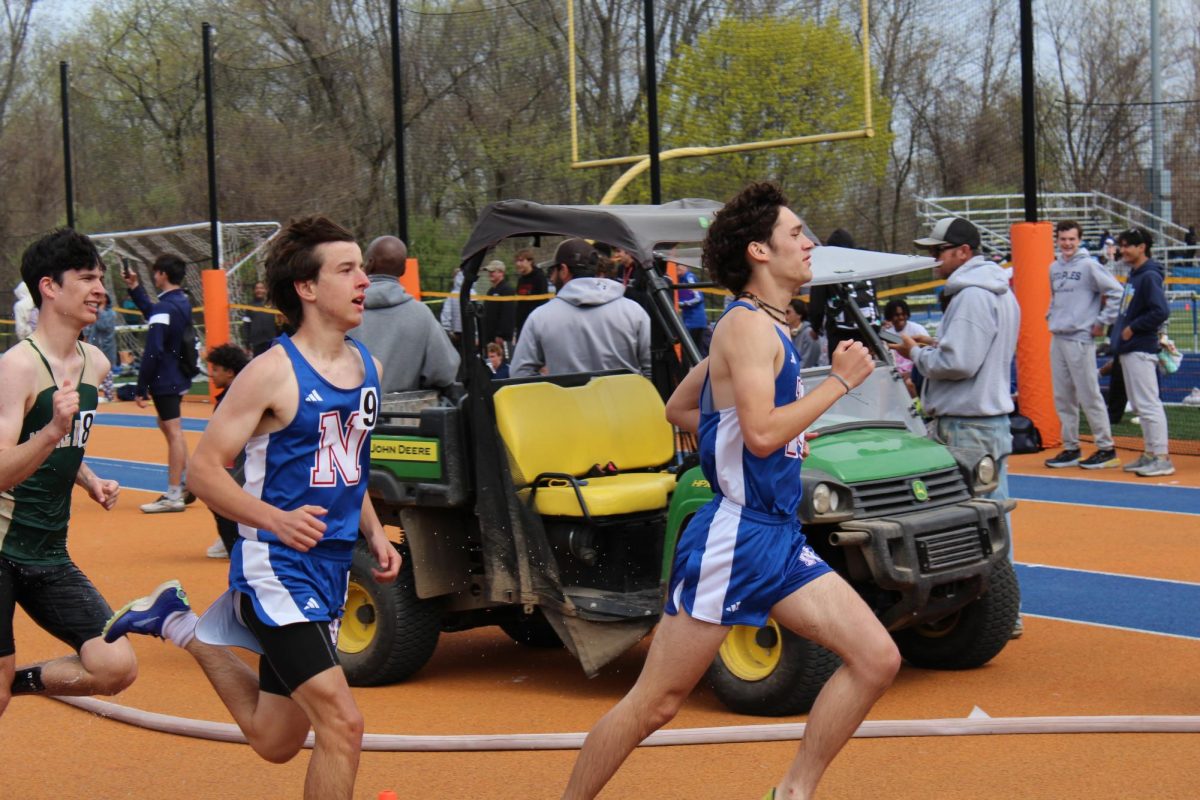 Senior captain Ethan Perez is in the front during the first lap of the boys steeplechase. Thatcher Budris closely followed behind him after the first water barrier.