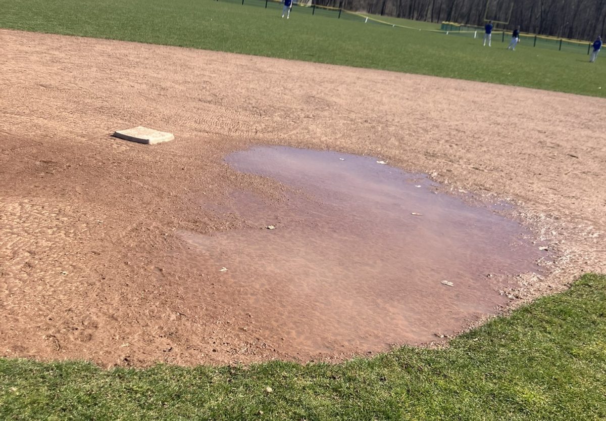 A puddle surrounds second base on Nonnewaugs baseball field earlier this month. Rainy weather has negatively impacted the start of the spring sports season. (Kyle Brennan)