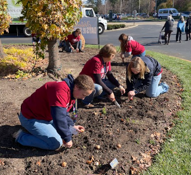 Woodbury FFA officers help to plant tulip bulbs into the ground outside of an art museum for a few hours in Indianapolis last October. Students who attended the annual FFA National Convention participated in the days of Living to Serve, a community service initiative.
