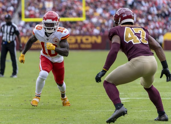 NFL wide receiver Tyreek Hill, left, was fined in 2023 for violating a league rule about his socks. (Courtesy of All-Pro Reels/Wikimedia Commons)