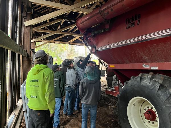 NHS Mechanics students examine a grain cart used at Christian Tobacco Farm while touring the facility. Students learned about Connecticuts rich history in growing one of the states largest crops from nearly a century ago. 