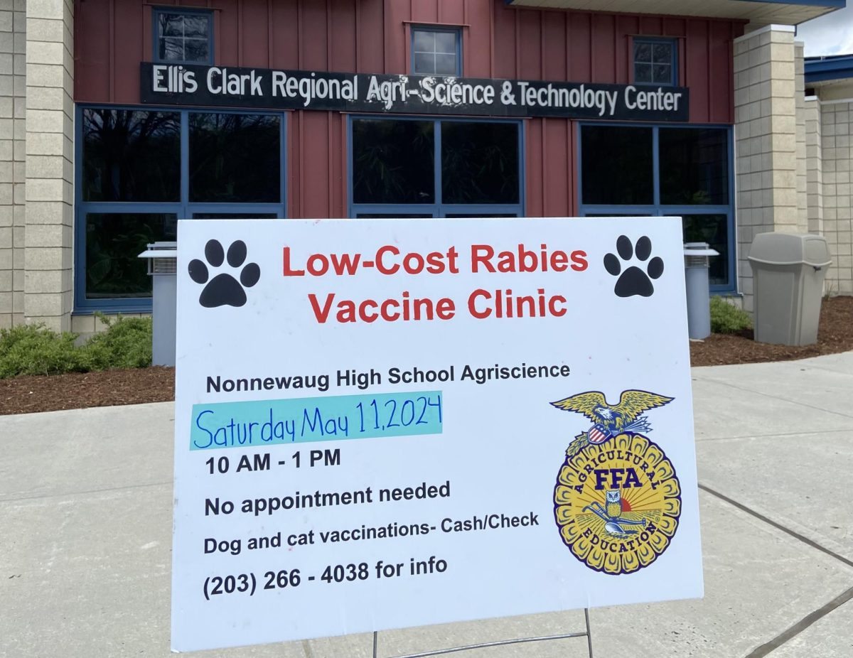 Signs advertise the low-cost rabies clinic at Nonnewaug on May 11.