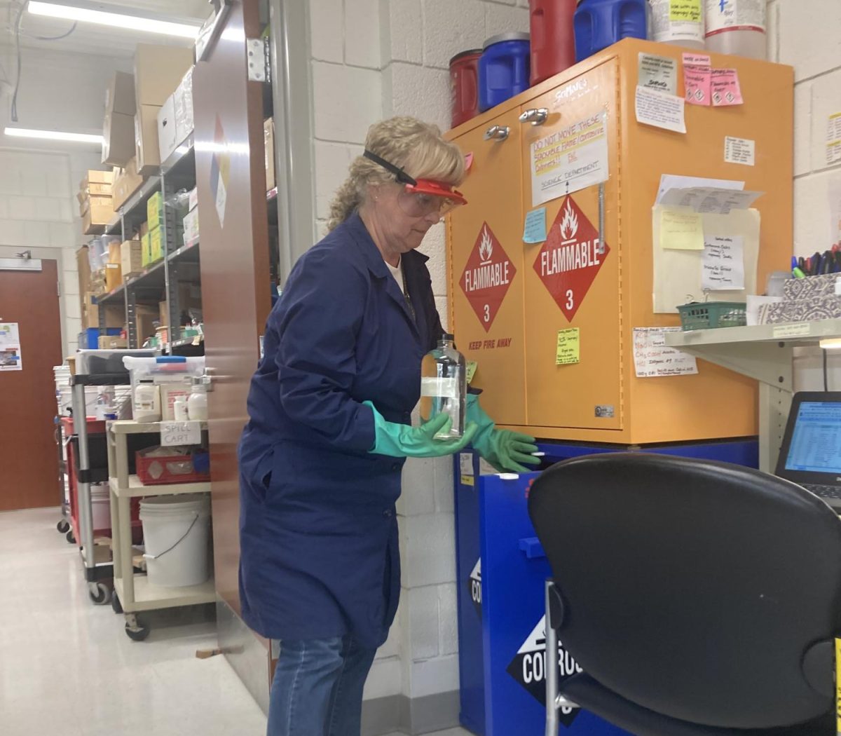NHS’ longtime science lab technician, Jean McDevitt, shows examples of combustible chemicals in one of Nonnewaug’s four science storage areas. McDevitt will retire at the end of the school year.