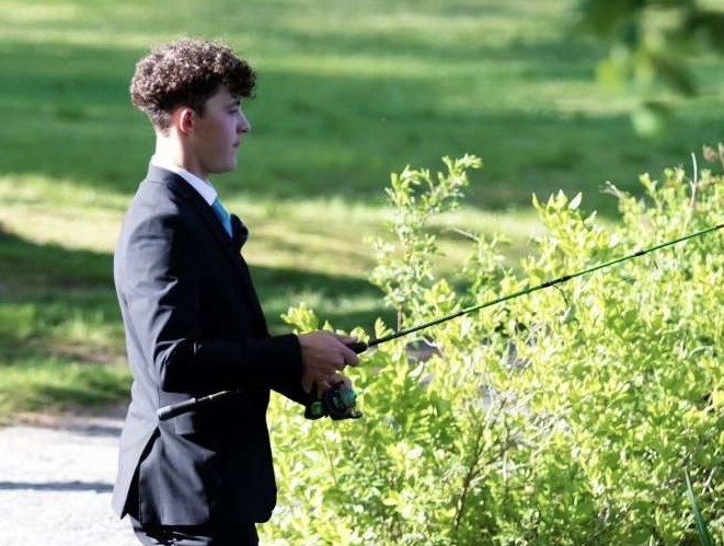 Nonnewaug student Lucas Savarese fishes in his suit prior to last years prom. Now a senior, Savarese is preparing for prom by sprucing up his truck and planning to buy flowers for his date. (Courtesy of Lucas Savarese)
