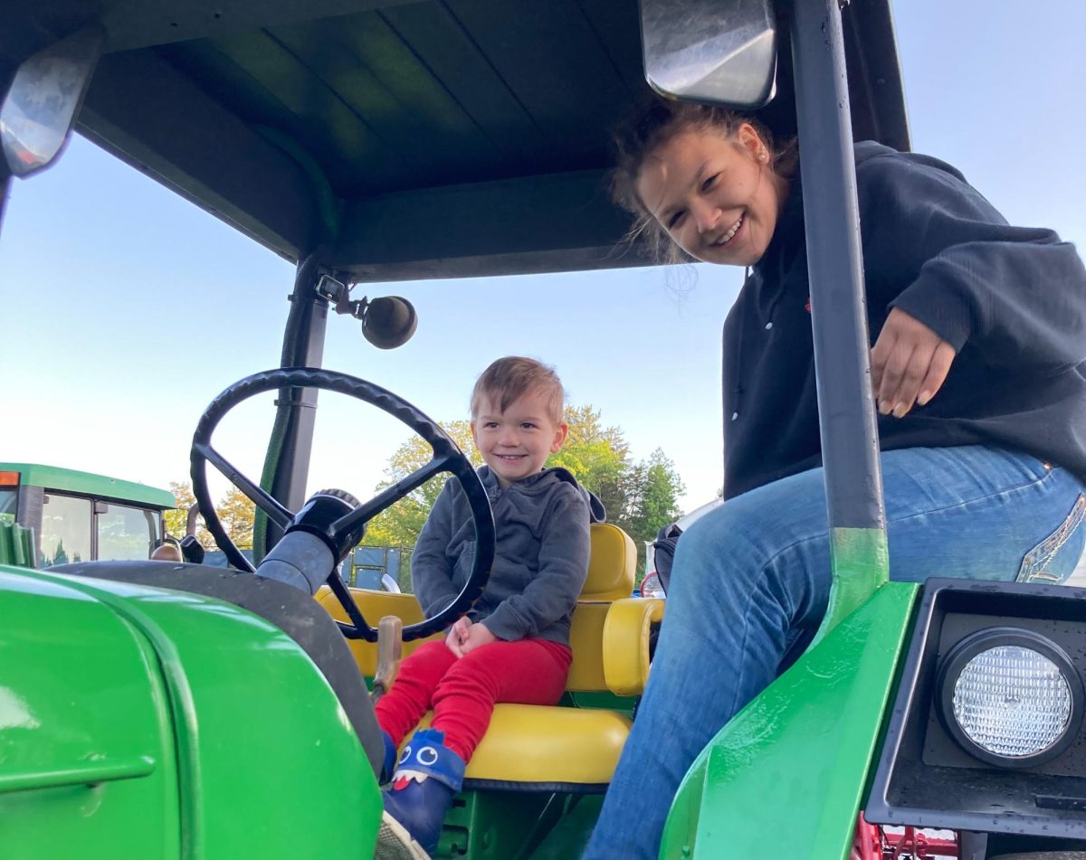Samara Thomas, NHS senior, sits with NHS faculty member Katy Aseltine’s son on a tractor during last year’s ‘Drive Your Tractor to School Day’ at Nonnewaug. 