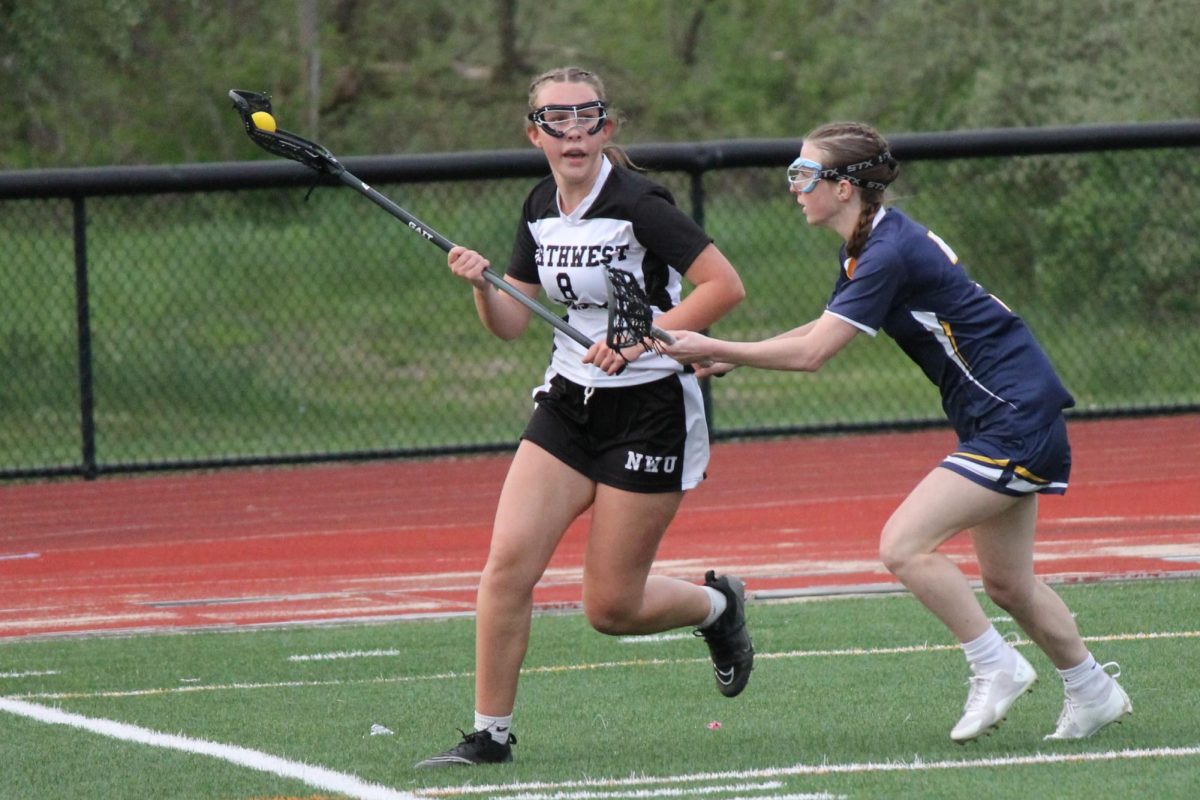 Jadyn Heron runs down the field with the ball during the Northwest United lacrosse game against Housatonic on May 3 at Nonnewaug.
