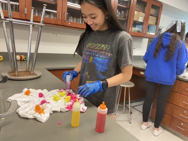 Ellie McDonald tie-dyes a T-shirt on May 3 in advance for her AP Chemistry exam. 