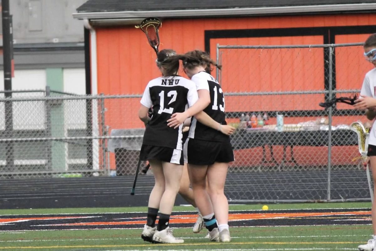 Gabby Guerra (12) and Kaitlyn Boyce (13) embrace one another during the Northwest United lacrosse game against Watertown on May 6 at Watertown.  