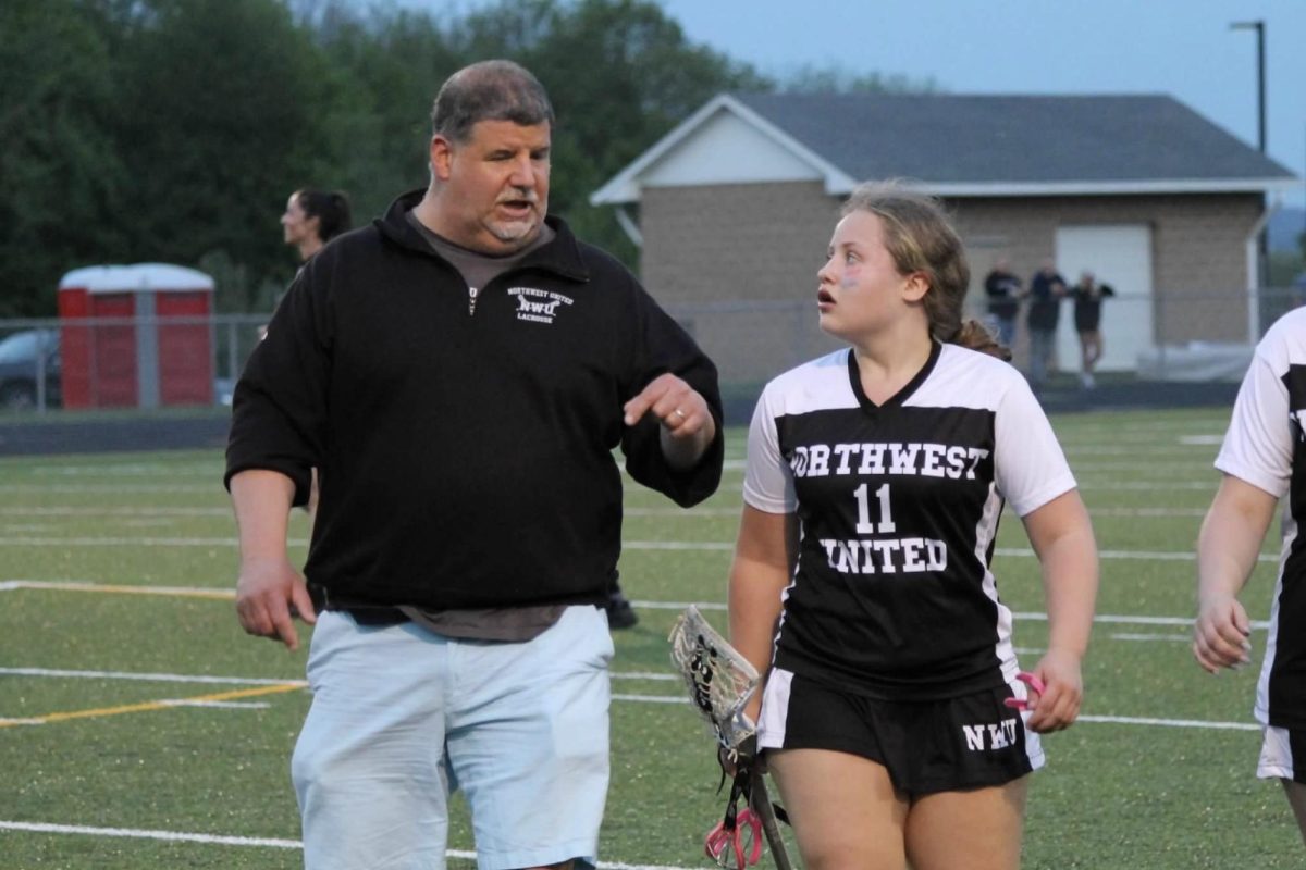 Mariah Manzano (11) talks with Coach Steve Boyce during the Northwest United lacrosse game against Watertown on May 6 at Watertown. 