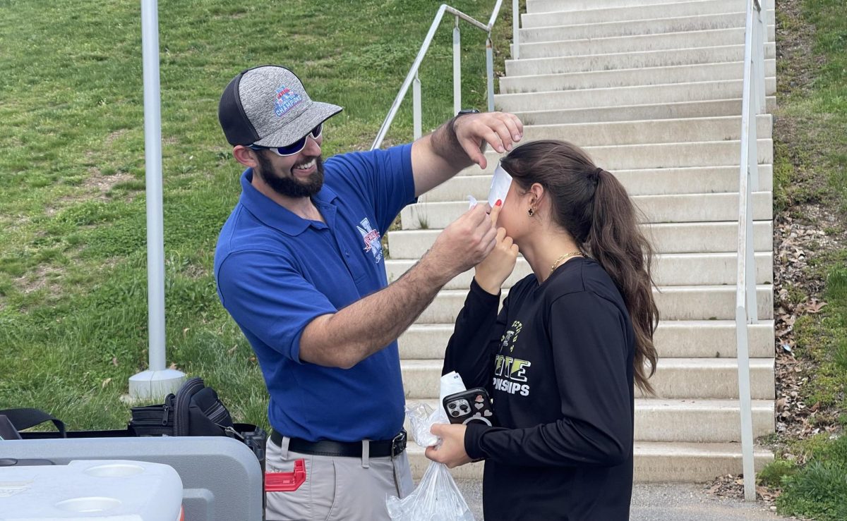 Nonnewaug+athletic+trainer+Sean+McGee+helps+Veronika+Nicholas+with+an+injury+before+practice+track.+McGee+will+be+on+campus+this+summer+assisting+athletes+with+summer+practices.+%0A