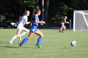 Nonnewaug's Ellie McDonald dribbles the ball during a game last season. McDonald's nickname is Smellie -- one of many "Chief names" that exist on the girls soccer team. (Courtesy of Noreen Chung)