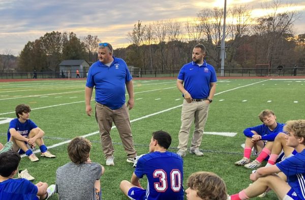 Nonnewaug boys soccer coach Toby Denman, left, and assistant coach Josh Kornblut address the team after a game last season. Denman says hes tried to learn how to be an effective coach by observing the ones hes played for and coached with. (Kyle Brennan)