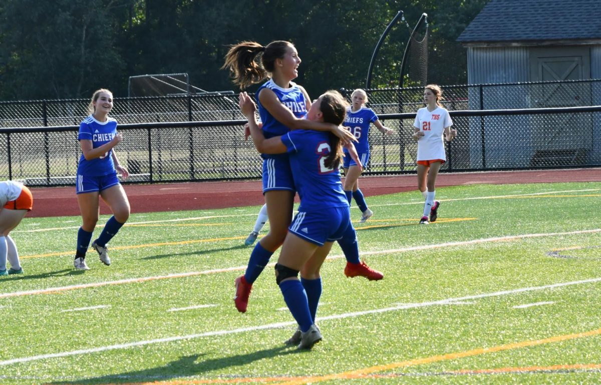 Hailey Goldman (11) jumps in excitement on Rosie Makarewicz (22) after scoring one of her two goals giving NHS the lead against Terryville during the girls soccer game against Terryville on Sept. 4 at the NHS turf.