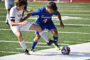 Durkin Stankevich (4) wins the ball with force during the boys soccer game against Northwestern on Sept. 13 at the NHS turf field. 