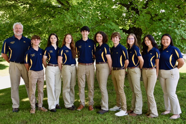 The 2024-25 Woodbury FFA chapter officer team stands together for a photo. From left, co-advisor Eric Birkenberger, Reporter Connor Cabeleria,  Secretary Merije Iljazi, treasurer Christa Freel, President Luciano Pedros, Historian Isabelle Longley, Sentinel Nathan Berry, Parliamentarian Abegail Diezel, Vice President Mia Layseca, and advisor Leanne Foster. (Courtesy of the Woodbury FFA)