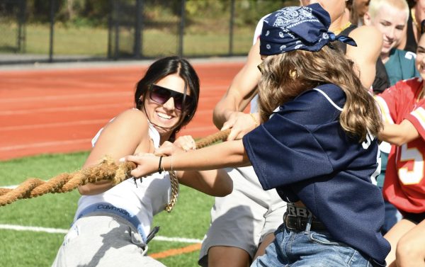 Julia Longoria, left, and Ava Hustek pull on the tug-of-war rope during the Class of 2025 Senior Field Day on Sept. 27.