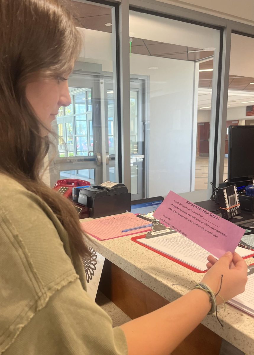 Iris Messore, sophomore at Nonnewaug 	gets handed a purple tardy slip, also known as the lunch detention slip, as a consequence of coming into school after the 7:25 bell. This lunch detention is new to the NHS this fall, with just one tardy u get a lunch detention that same day. 