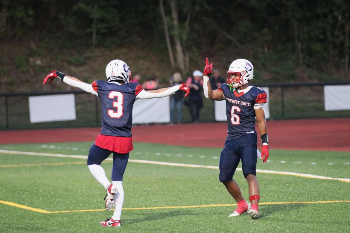 Derek Chung, left, and Davion Joe celebrate after Chung scores a touchdown Sept. 13 vs. Stratford. Both Chung and Joe developed in the program's junior varsity pipeline. (Courtesy of Noreen Chung)