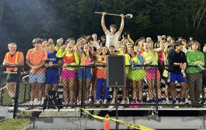 Nonnewaug's student section cheers for the Northwest United football team Sept. 13 when the game theme called for neon. The homecoming sports day Sept. 19 will be a gold-out to support Childhood Cancer Awareness Month. (Courtesy of Kyle Brennan)