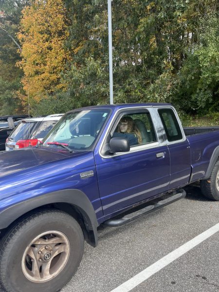 Abigail Risi waits in her truck wishing to leave campus, resembling what she can no longer do -- leave campus and return.