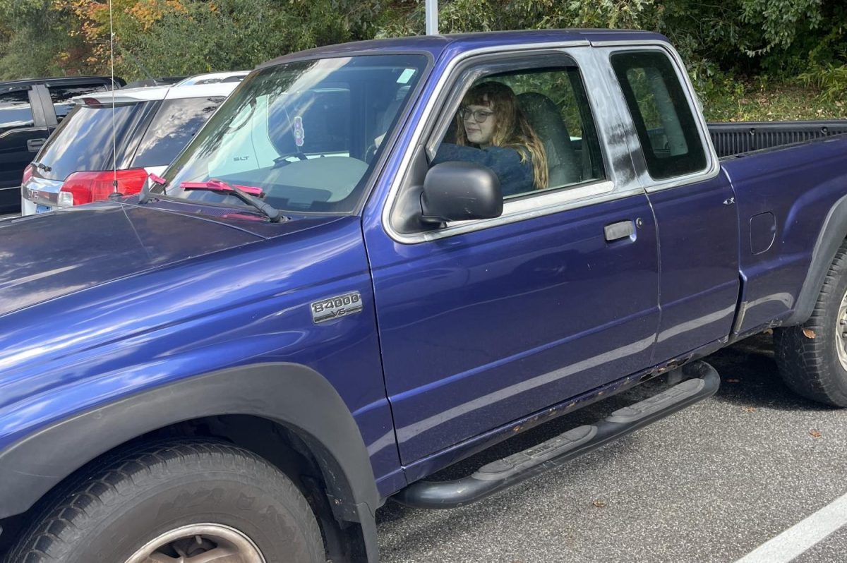 Abigail Risi waits in her truck wishing to leave campus, resembling what she can no longer do -- leave campus and return.