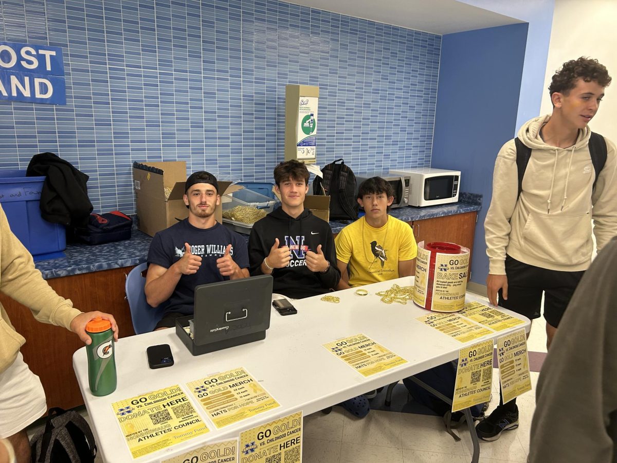 From left, Jeffery Bernardi, Matthew Shupenis and Liam Sandor sit at the table during lunch trying to sell glasses, bandanas, bracelets and necklaces to benefit the Tommy Fund.