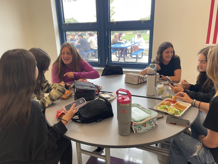 From left to right: Julia Gwiazdoski, Hailey Goldman, Laila Jones, Gianna Desjardins, Rosemary Makarewicz, and Greta Addeo enjoy lunch on a game and practice day. Some students choose to bring lunch from home or eat what's provided by lunch staff to fuel their bodies for sports. 