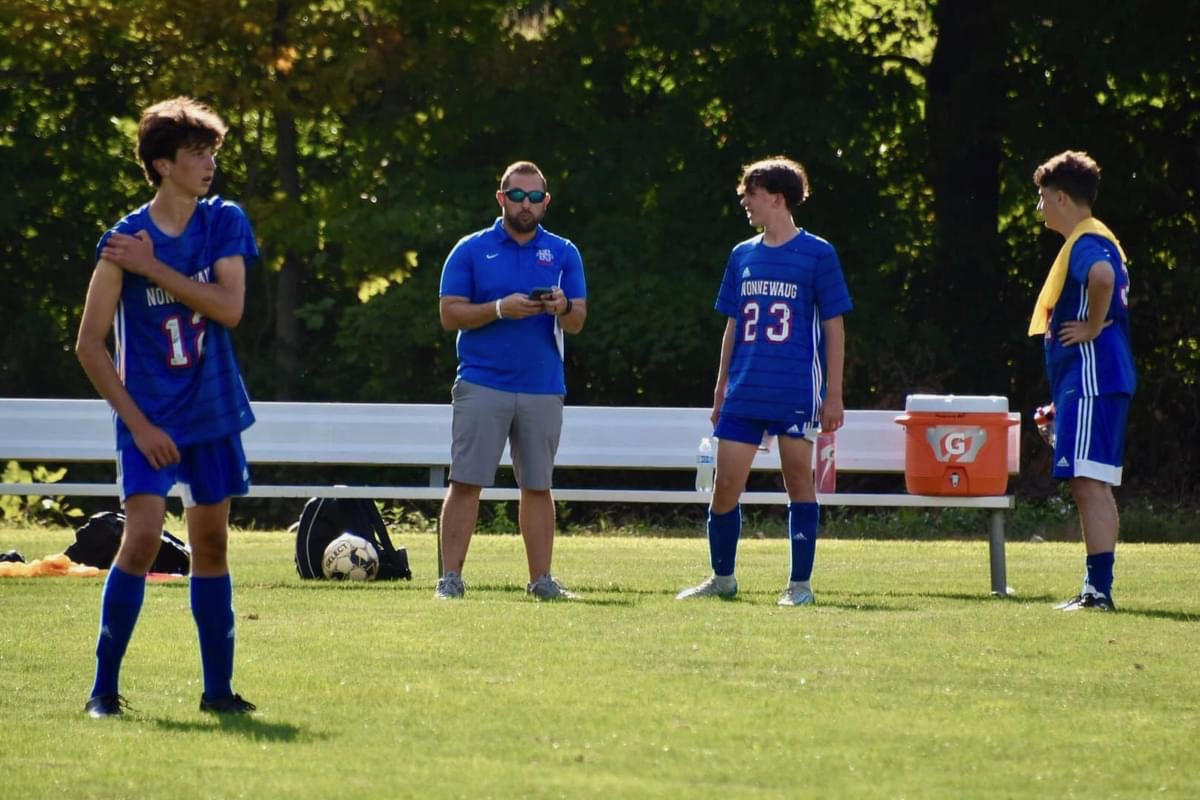 Freshman Kaden Coons (23) talks to JV boys soccer coach Josh Kornblut during the game against Northwestern on Sept. 12. Many freshmen join teams when they get to Nonnewaug. (Courtesy of Tara Herr)
