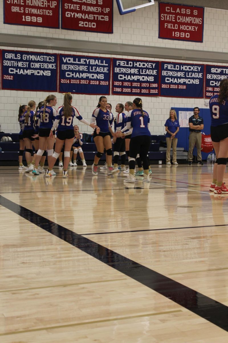 Sophomore Lana Zupnick (33) walks through the team as her name gets called for being a starter during Nonnewaug's volleyball match against Gilbert on Sept. 19.