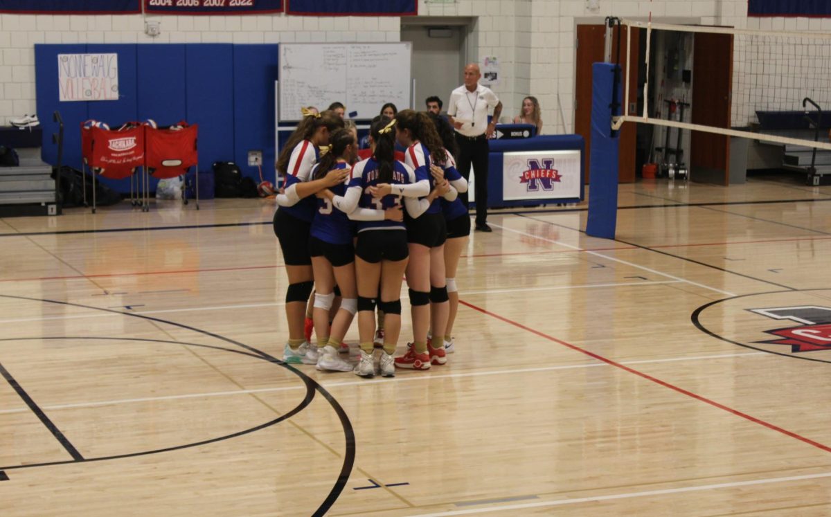 The NHS volleyball team huddles before the game to hype each other up during Nonnewaug's volleyball match against Gilbert on Sept. 19.