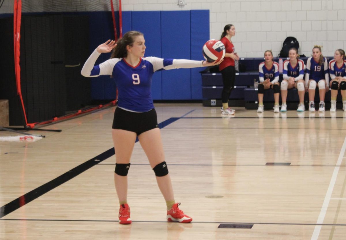 Senior captain Chloe Weaver (9) gets in position to serve during Nonnewaug's volleyball match against Gilbert on Sept. 19.