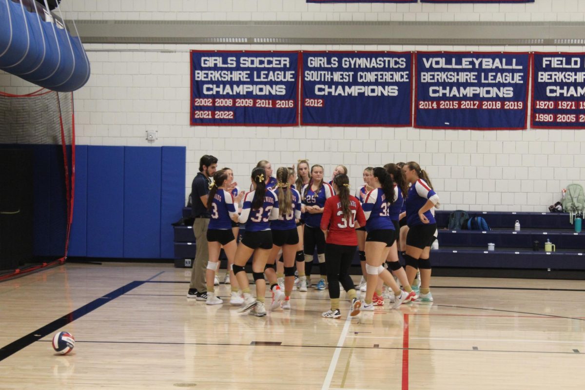 The NHS volleyball team huddles together during a timeout during Nonnewaug's volleyball match against Gilbert on Sept. 19.