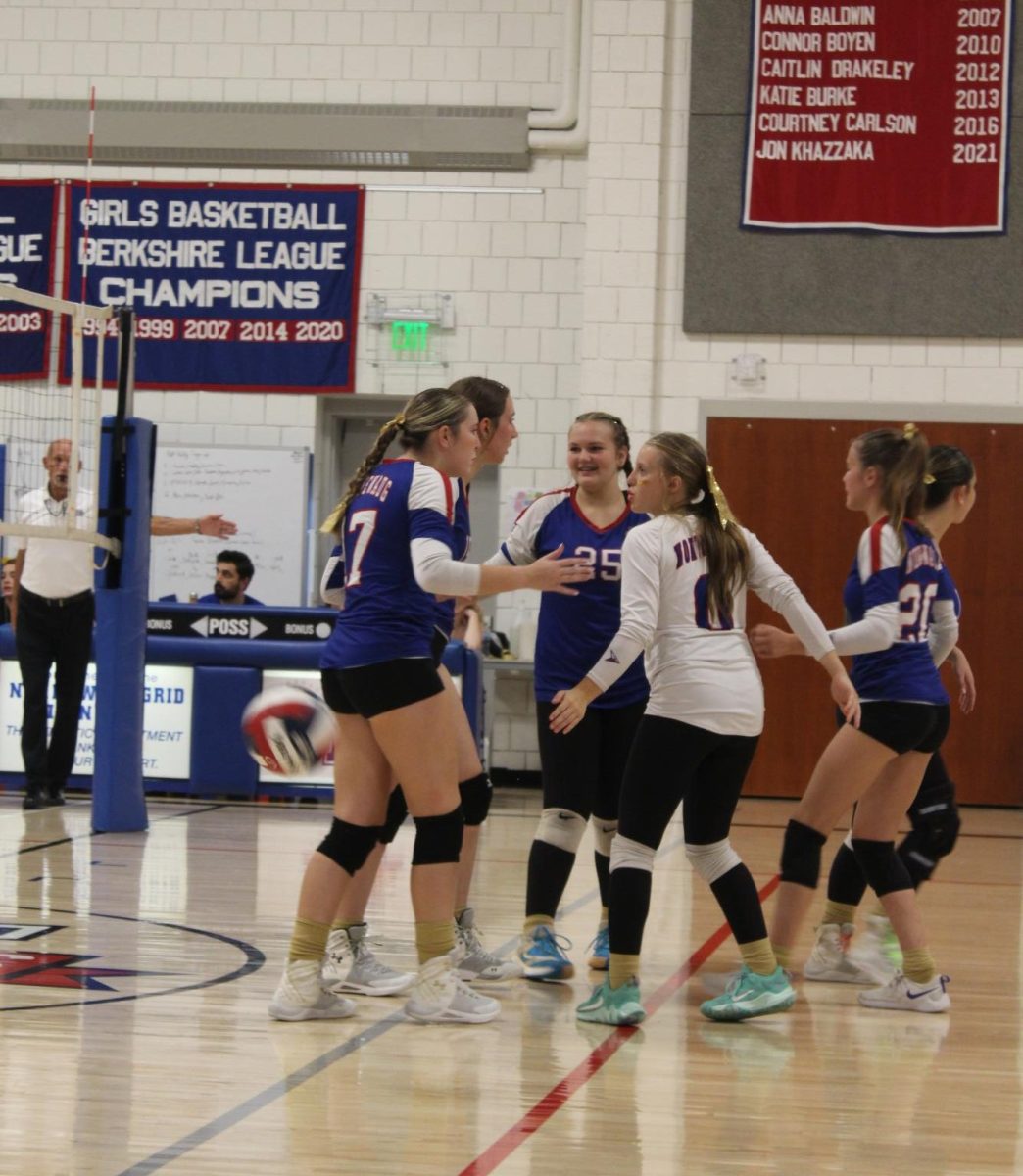 The girls gather with excitement after a point during Nonnewaug's volleyball match against Gilbert on Sept. 19.