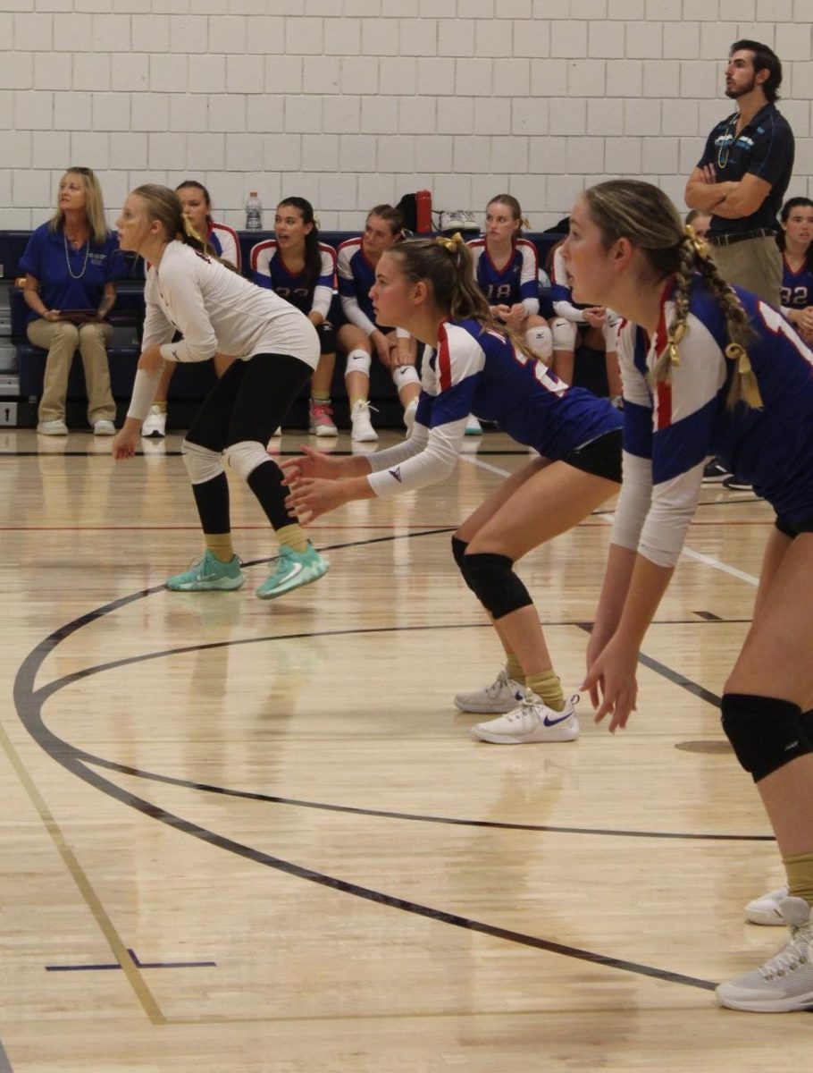 From left, Jordan Kovach, Boe Stokes, and Isabella Sylvester await a serve during Nonnewaug's volleyball match against Gilbert on Sept. 19.