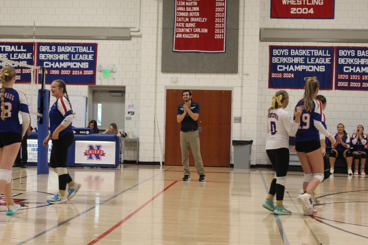 NHS volleyball coach Marty Malaspina claps after a play during Nonnewaug's volleyball match against Gilbert on Sept. 19.