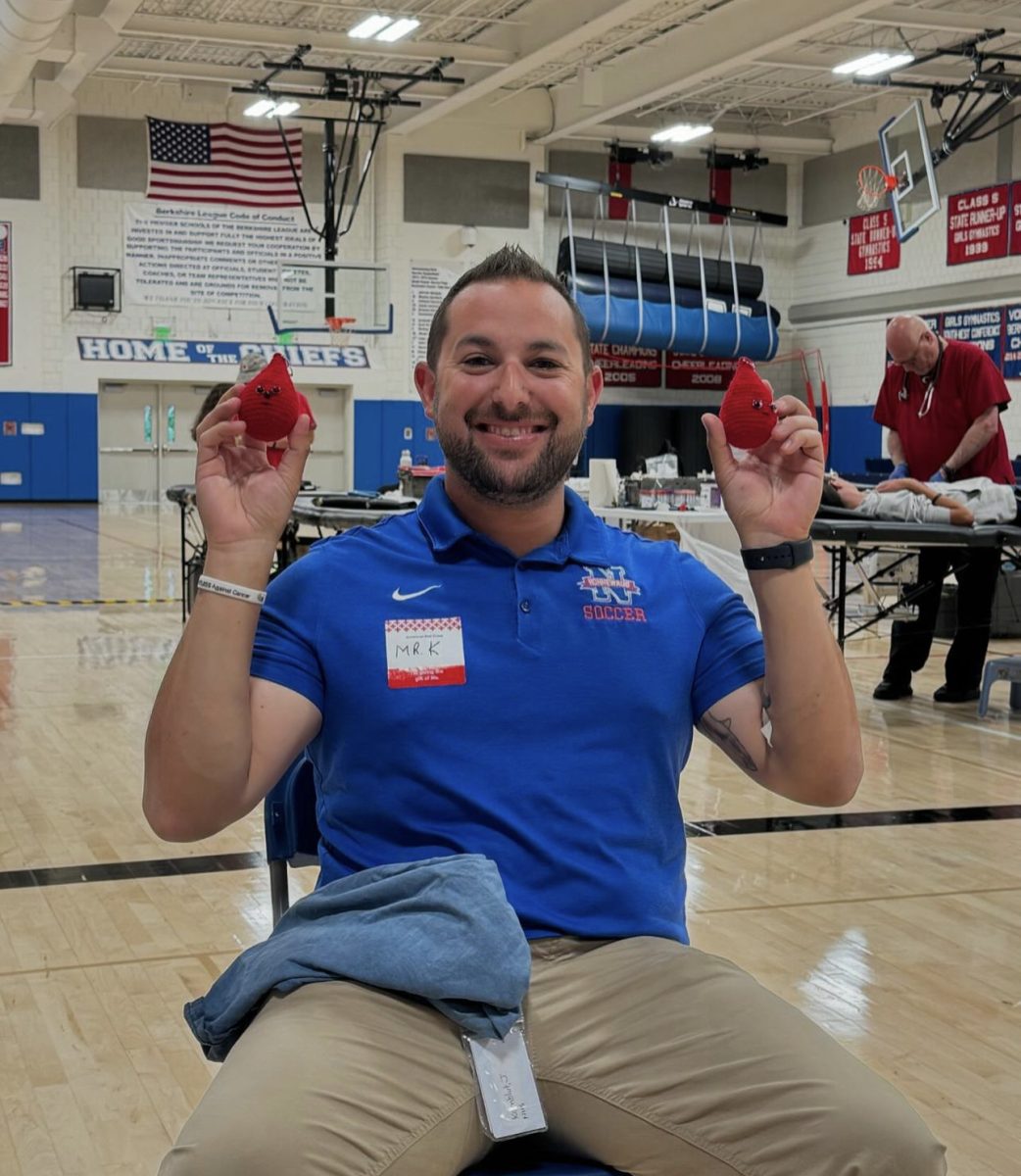 Joshua Kornblut, one of the science teachers at Nonnewaug, smiles while holding two crocheted blood drops. Kornblut is one of the donors at the blood drive. Who donated On September 17th. (Courtesy of NHS National Honor Society Instagram)
