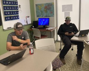 Students Nick Mancini (left) and Levi Johnson (right) utilize their study halls to contact their employers. Some NHS students are struggling to find free time for a simple text back. 