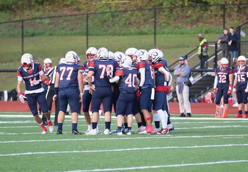 Northwest United football players embrace before a play on Sept. 13th in a 21-20 defeat against Stratford. The team losing Wolcott Tech next season is upsetting to those who have built bonds with teammates. (Courtesy of Noreen Chung)