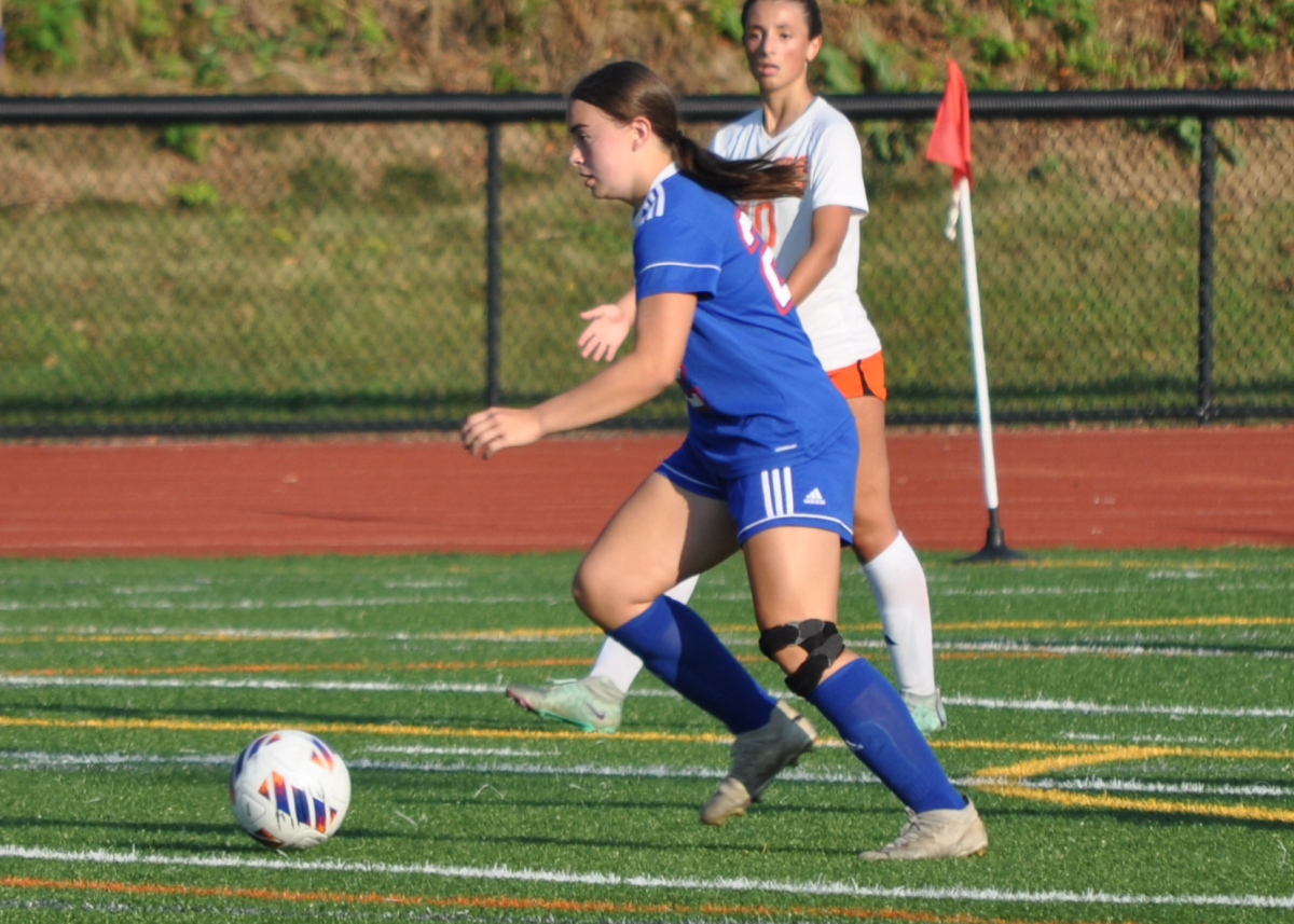 Freshman Rosie Makarewicz dribbles the ball up the field during a game against Terryville on Sept. 4. Makarewicz is a starter on the varsity girls soccer team. (Courtesy of Jennifer Salisbury)