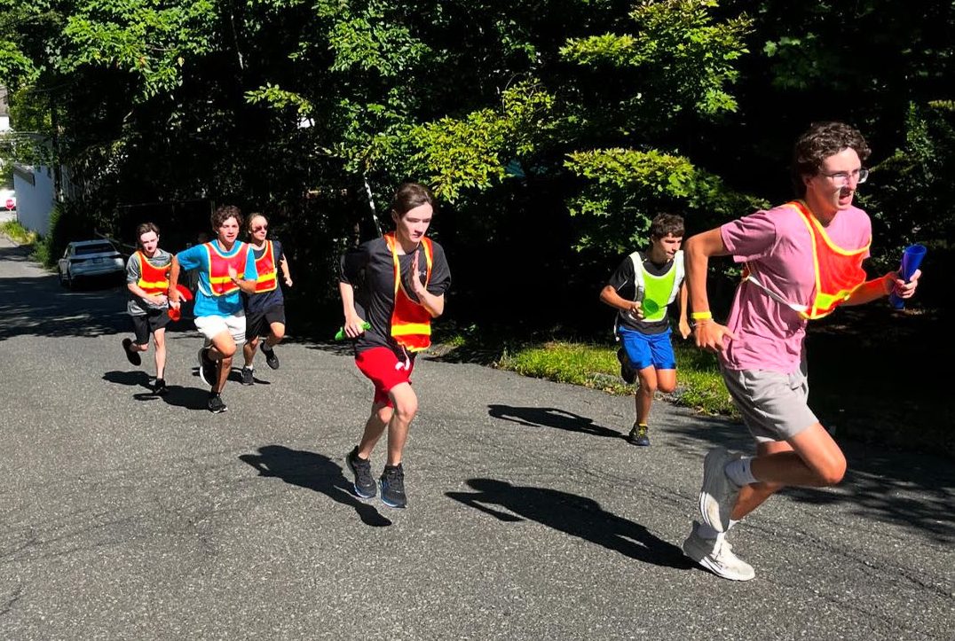 Nonnewaug cross country runners race up a hill during their summer training timed mile. This hard work during preseason allows them to be better prepared when the real season comes. (Courtesy of Nonnewaug cross country/Instagram)
