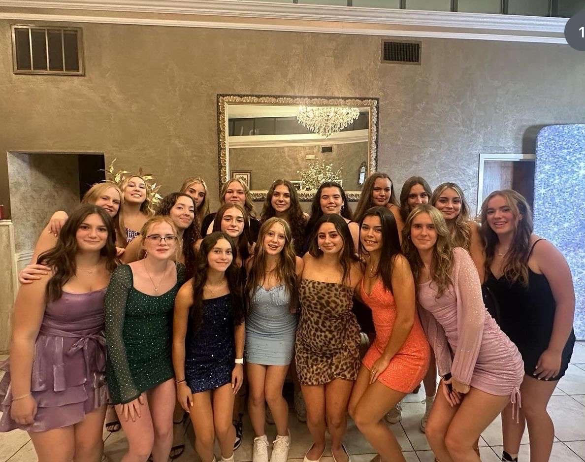 The NHS volleyball team stands together as the pose to take their annual homecoming photo on Sept. 20. (Courtesy of Lana Zupnick)