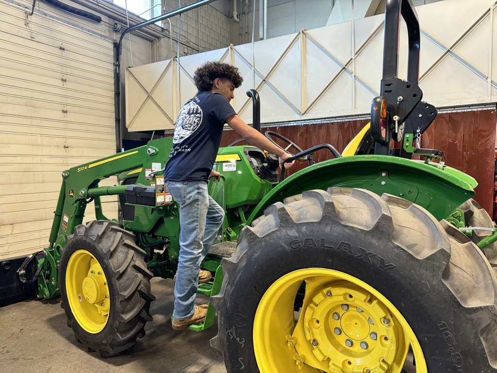 Joshua Spataro boards NHS' new John Deere tractor, an investment that will interest a lot of FFA students and teachers. A reliable piece of equipment makes a huge difference for agriculture classrooms.