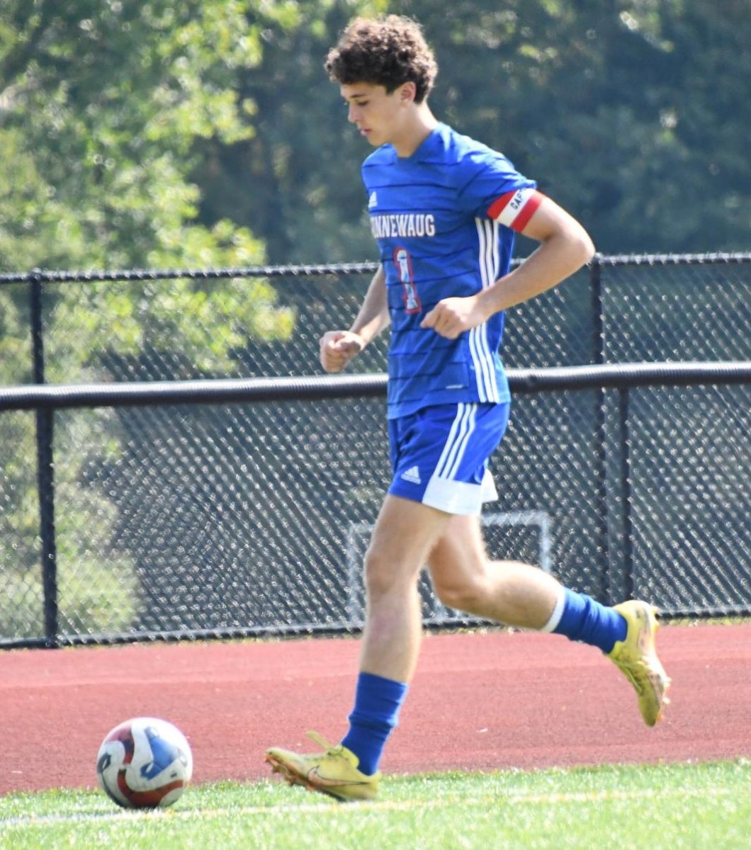 Lincoln Nichols (1) runs with the ball at the boys soccer game against Northwestern on Sept. 13. Nichols says that some athletes feel pressure playing in front of big crowds.